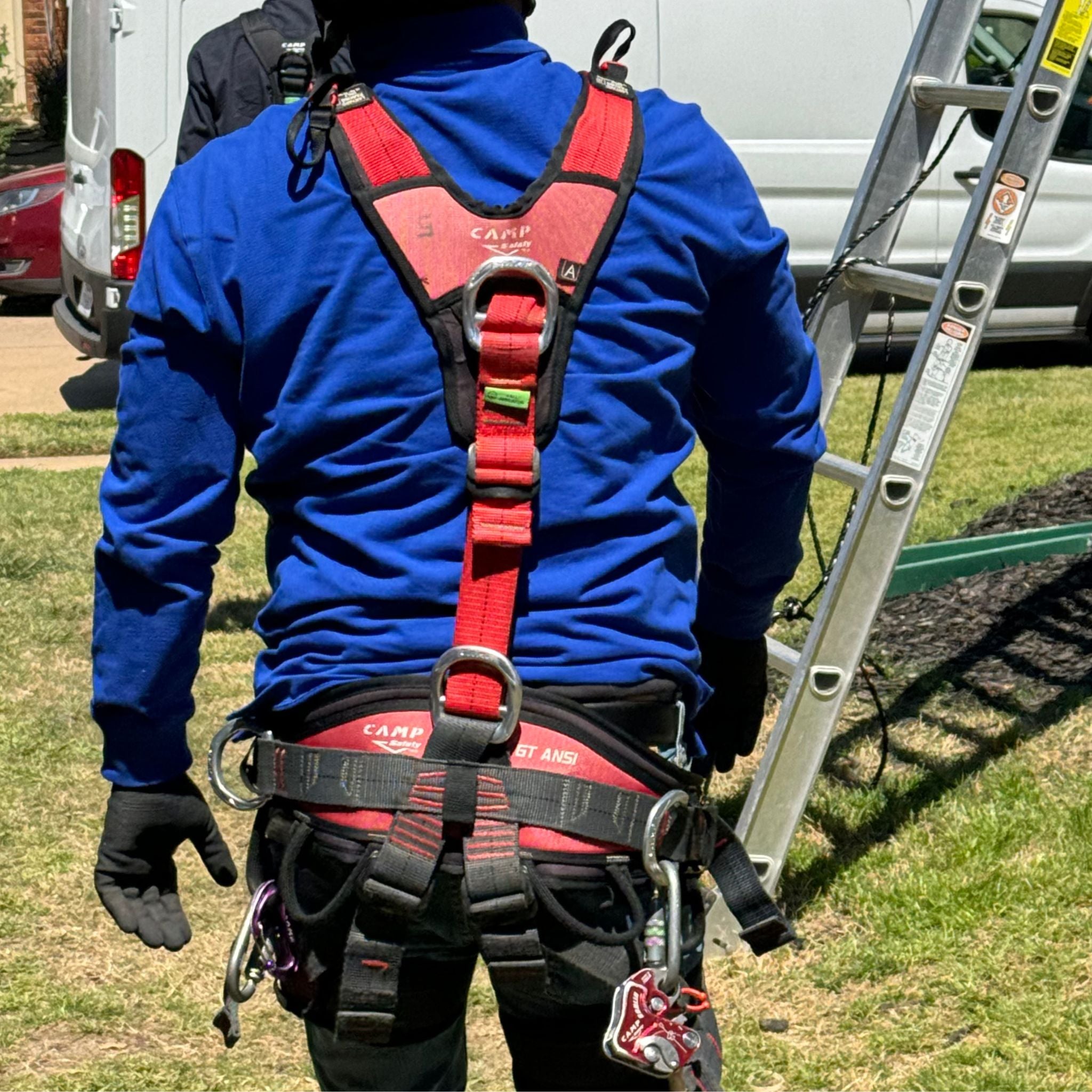 Sloped roof worker in PPE and CAMP GT XT Harness walking to finish Eveook Fall Protection System installation