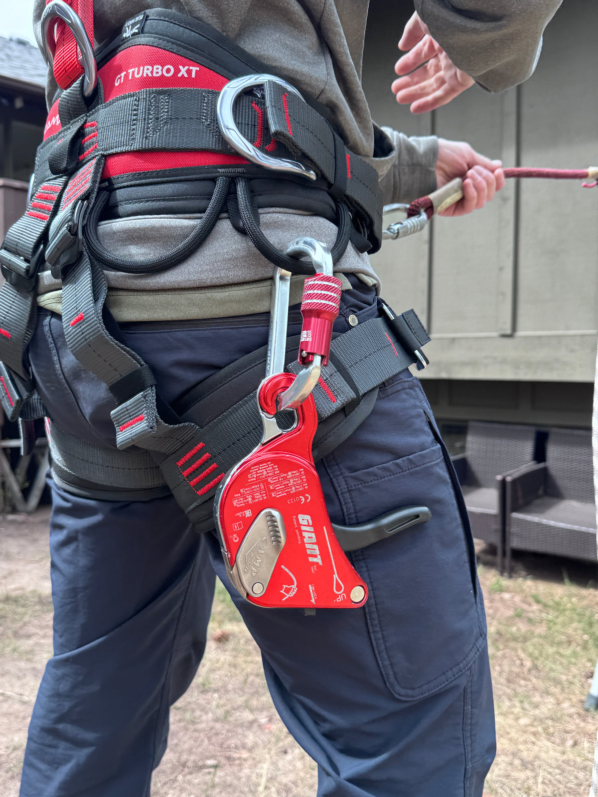 Close up of roof worker in roof safety harness with PPE with a CAMP Giant on his harness loop using the Eveook Fall Protection System