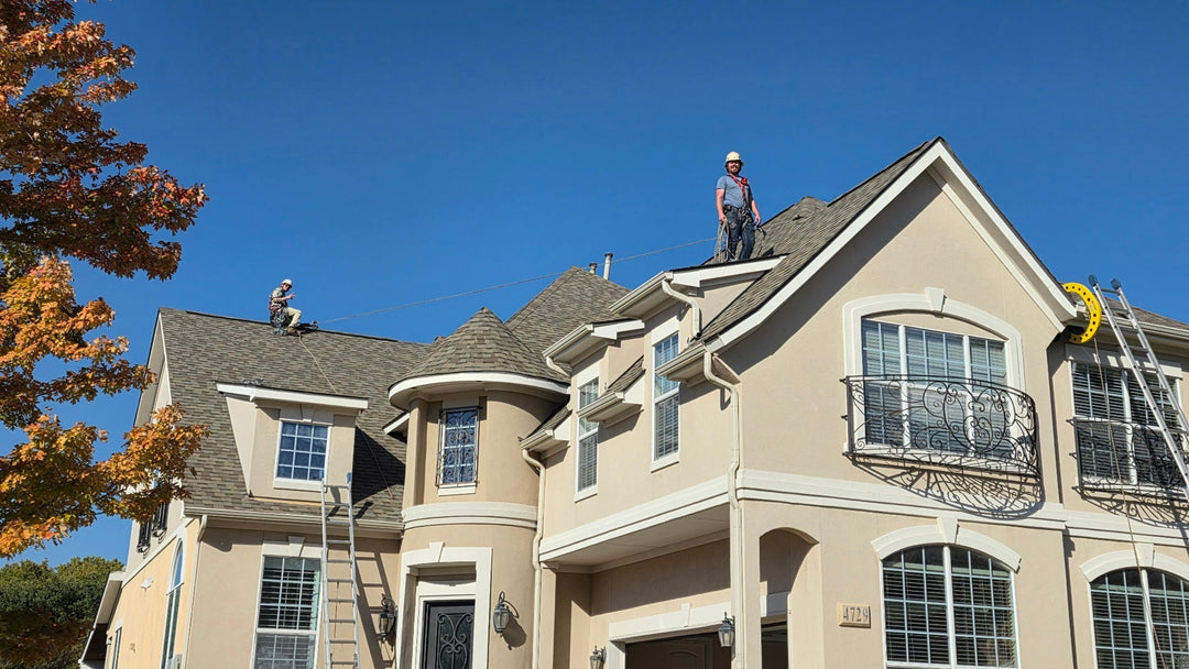 Installer using the Eveook™ Fall Protection System on a steep roof to hang Christmas lights safely — same method used by Jurassic Lawn Care’s professional lighting crews.