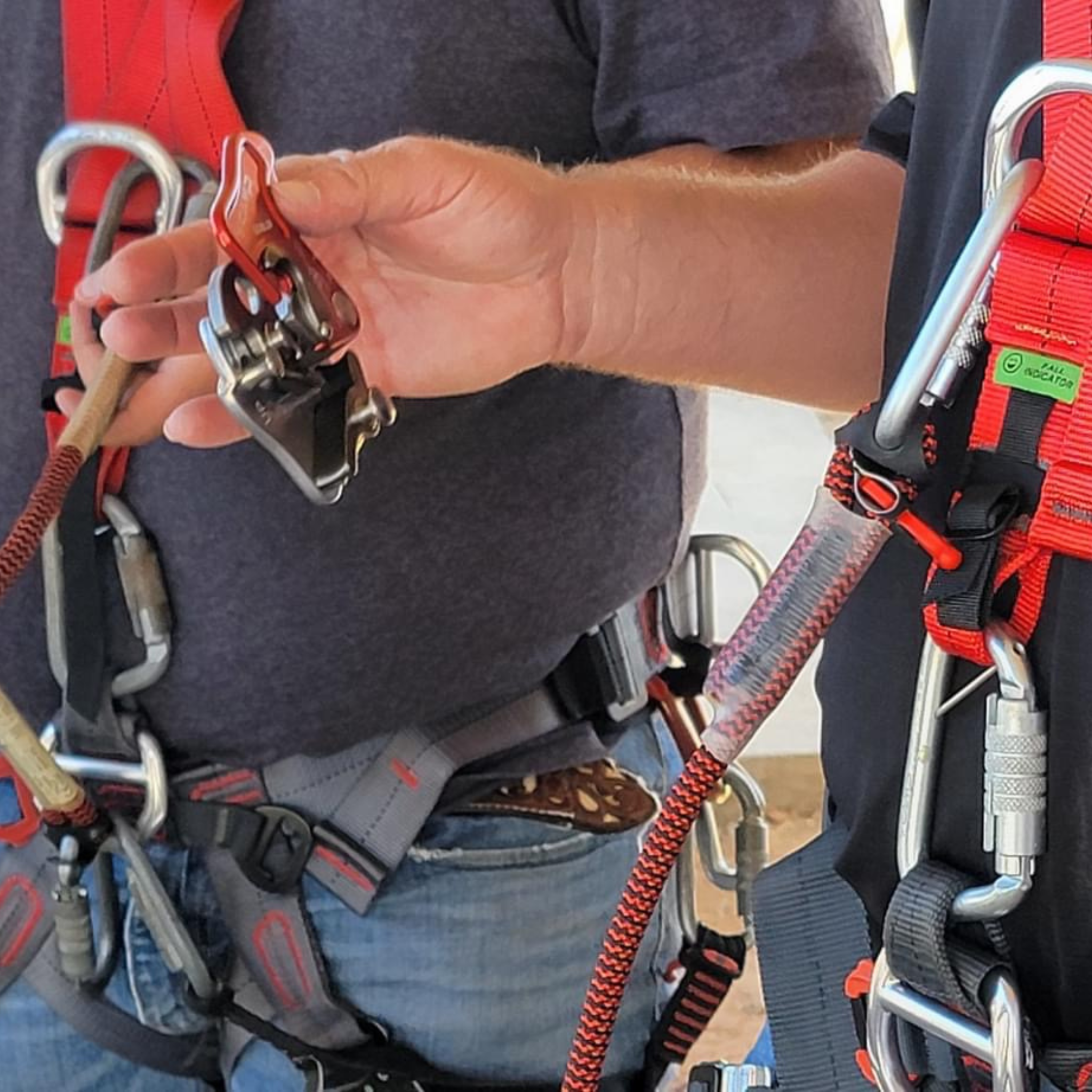 Roof workers wearing roof harnesses and using personal gear like the CAMP goblin as shown using the Eveook Fall Protection System