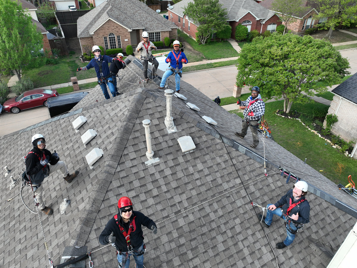 8 roof workers attached to non-penetrating roof anchor system for fall protection the Eveook System 