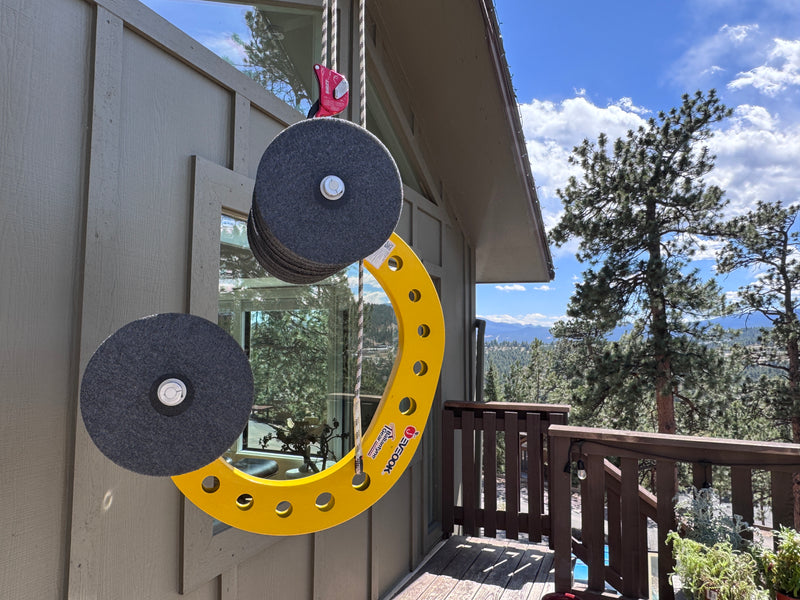 Eveook Fall Protection System hanging on a wooden deck with trees and sky in the background