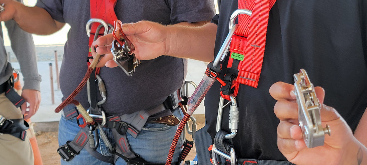 Close up of open CAMP Goblin Fall Arrester at a jobsite with a group of fall protection installers