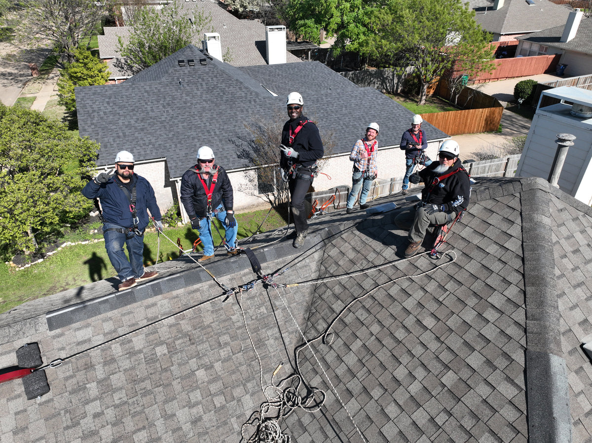 Group of roof workers on a roof with Eveook Fall Protection roof safety equipment being used. 